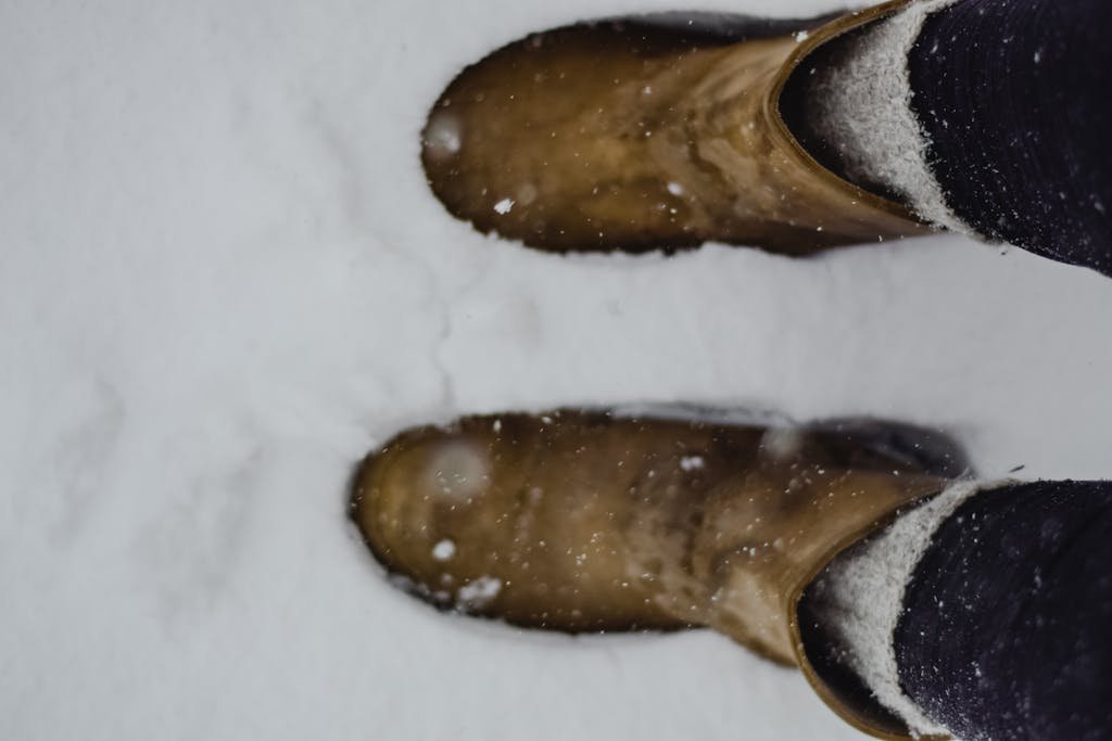 A close-up shot of winter boots in fresh snow. Perfect for winter lifestyle themes.
